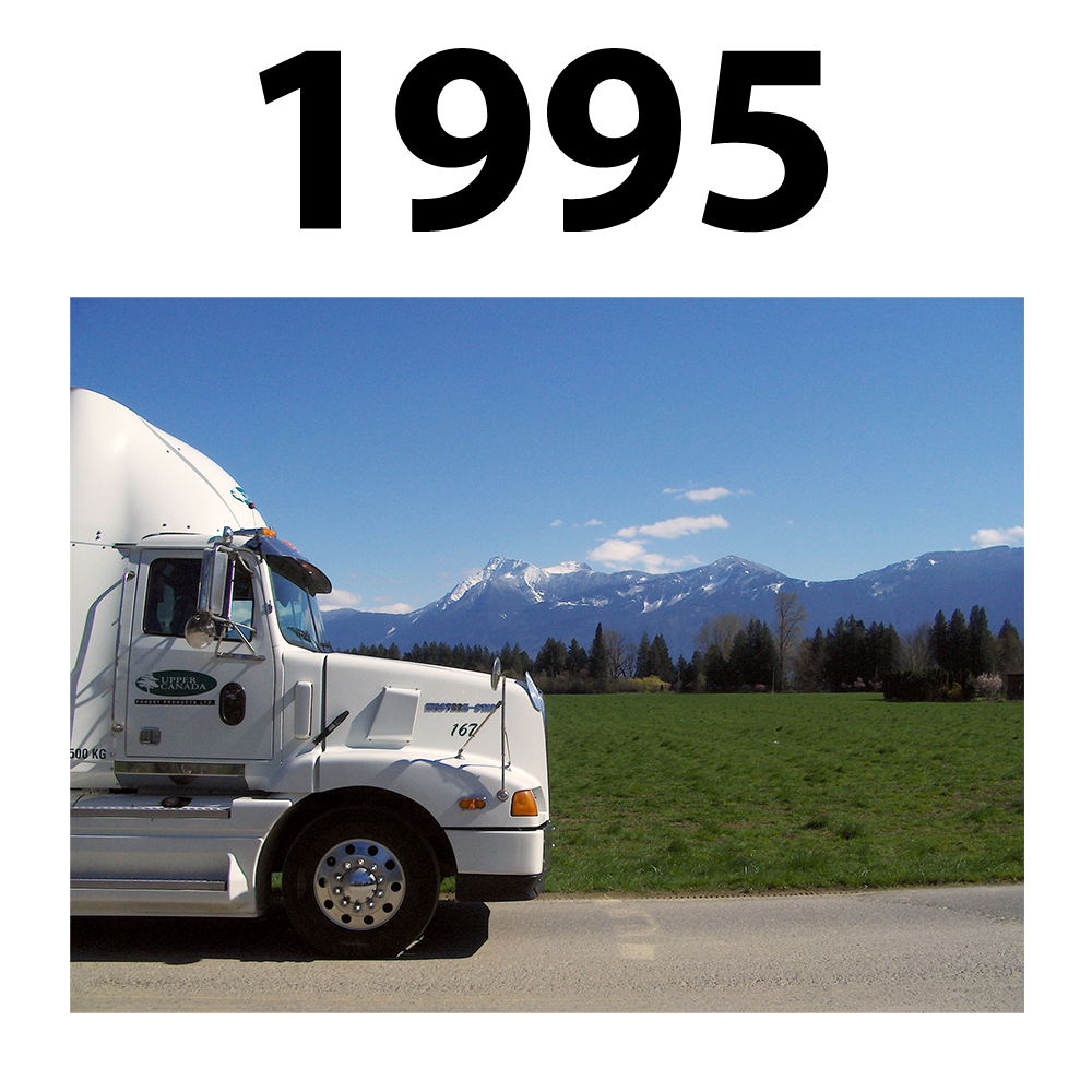 Upper Canada Forest Product Truck against mountains in British Columbia